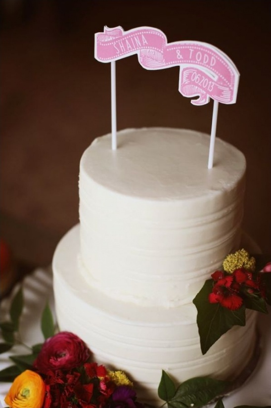 Shaina and Todds wedding cake with topper and flowers