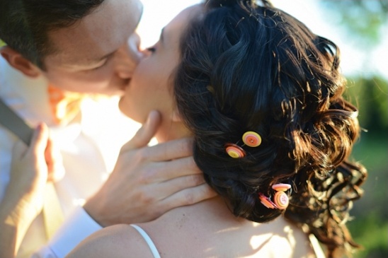 Newlyweds share a romantic kiss outdoors