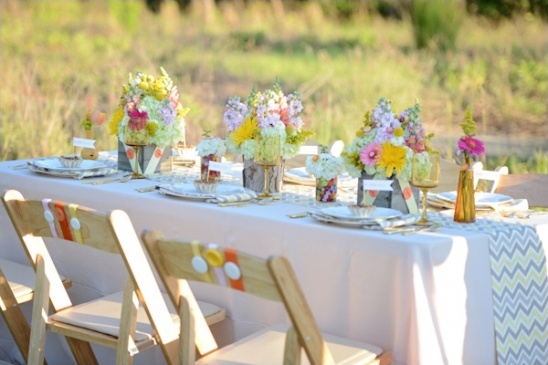 Outdoor dining table with floral arrangements decor
