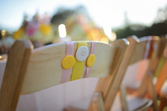 Decorated chairs with buttons at a wedding reception