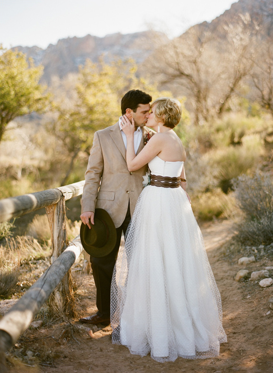 Couple kissing, wedding dress, desert setting