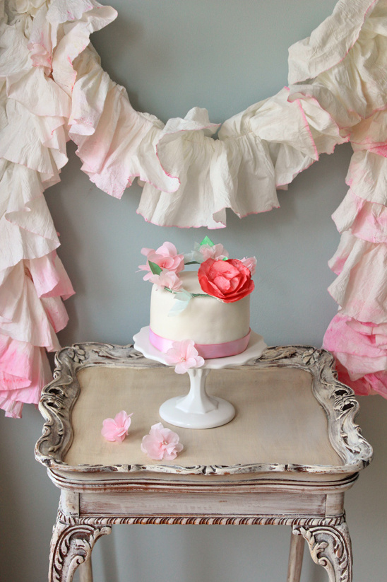 Elegant cake with floral decor on a vintage table