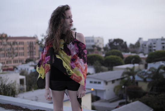 Woman in floral top looking at urban skyline view