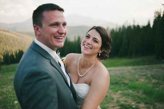 Happy couple smiling on their wedding day in the mountains