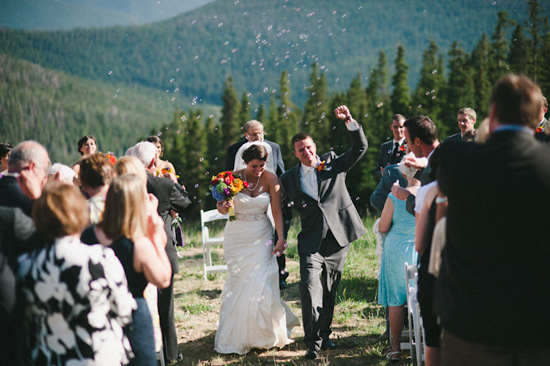Happy couple celebrates mountain wedding with bubbles