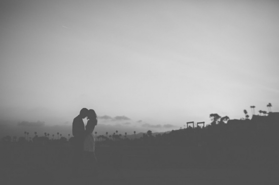 Silhouette of couple embracing at sunset love concept