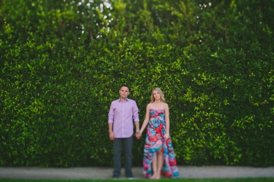 Couple in front of green hedge