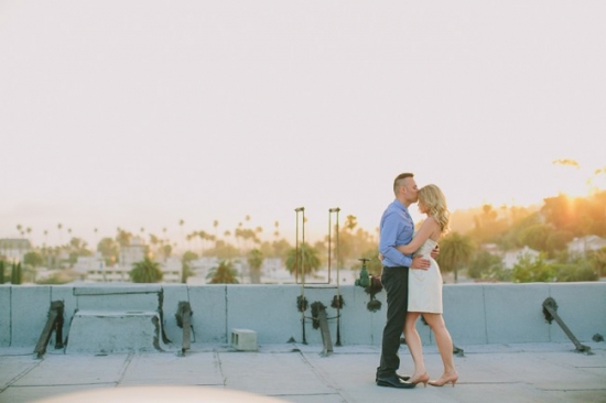 Couple embracing rooftop sunset