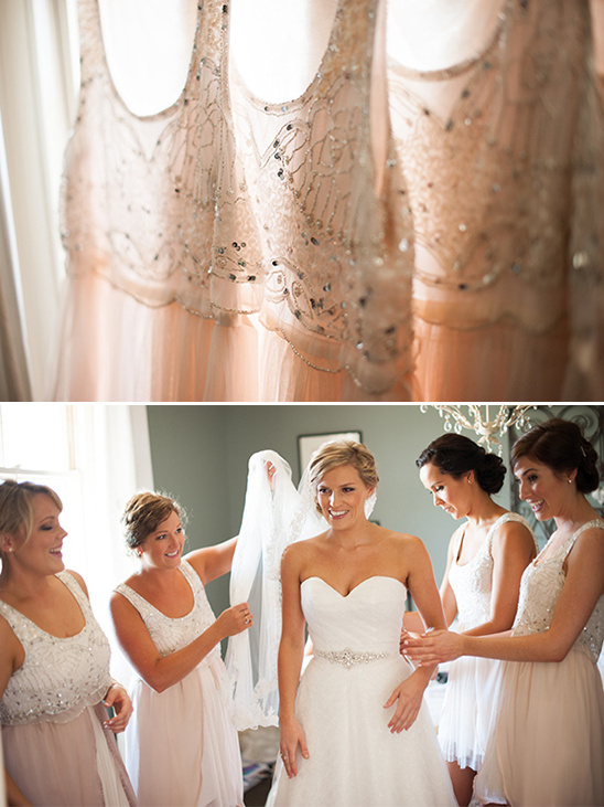 Bridesmaids helping bride prepare in elegant dresses