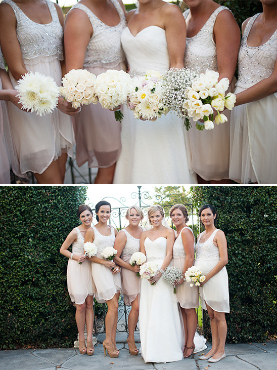 Elegant bride with bridesmaids in blush dresses and white bouquets