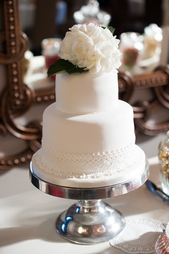 Elegant two-tiered wedding cake with white flowers