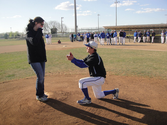Man proposes to woman on baseball field