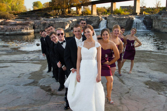 Wedding party by river, bride in white dress