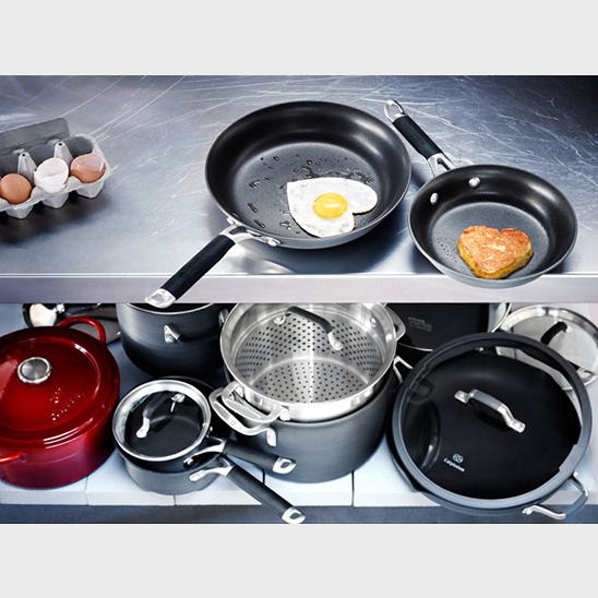 Heart-shaped fried eggs in frying pans and cookware