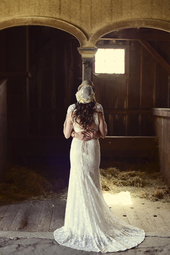 Rustic wedding couple embracing in a barn location