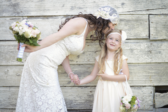 Bride kisses flower girl on the forehead wedding photo