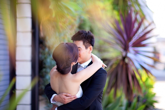 Asian couple kissing tenderly on their wedding day