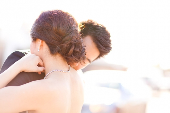 Romantic hug of a newlywed couple in bright sunlight