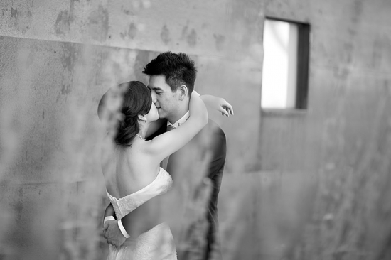 Black and white photo of a bride and groom kissing
