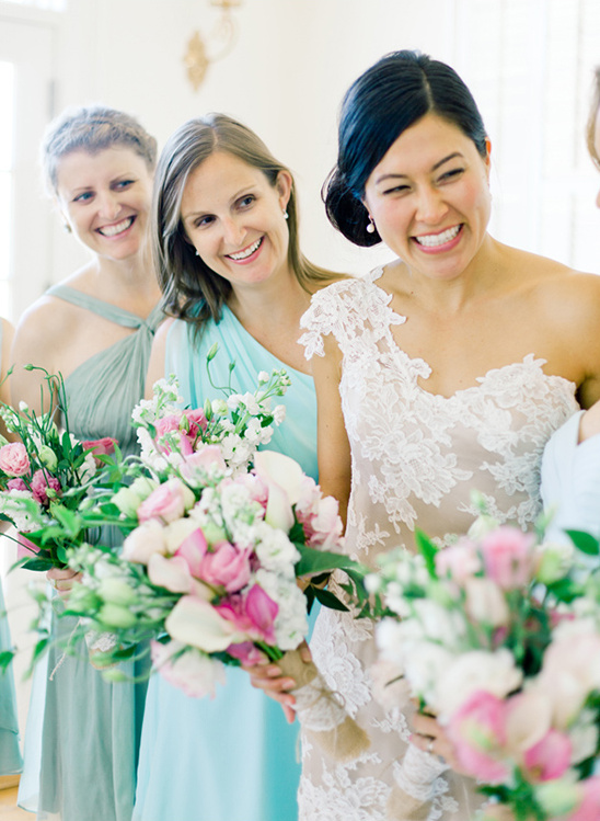 Happy bridesmaids holding bouquets at wedding