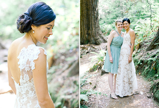 Bride in lace dress with friend at outdoor wedding
