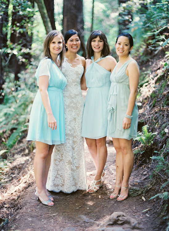Bride with bridesmaids in light blue dresses outdoors