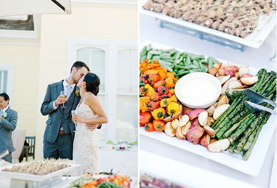 Bride and groom share a kiss at outdoor wedding buffet