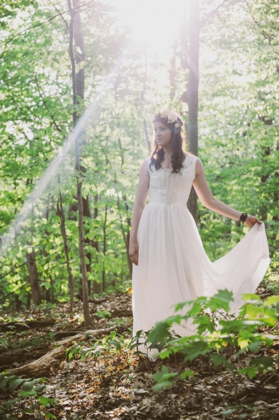 Woman in white dress in sunlit forest