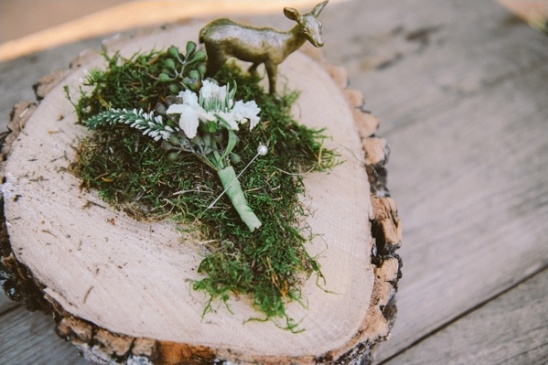 Rustic wood slice with moss deer and boutonniere detail