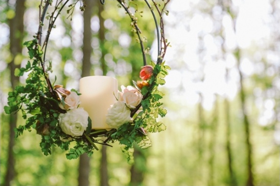 Floral hoop with candle in the woods wedding decor