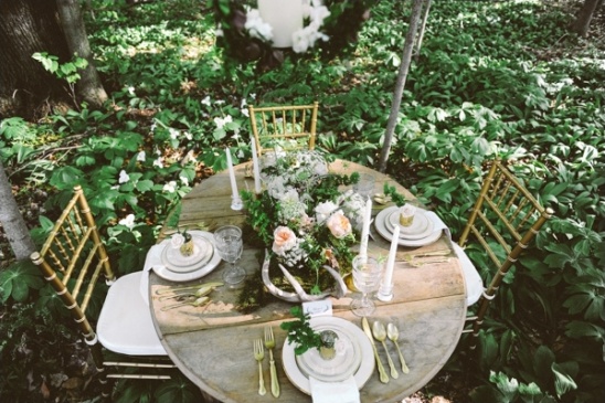 Rustic outdoor wedding table setting with floral centerpiece
