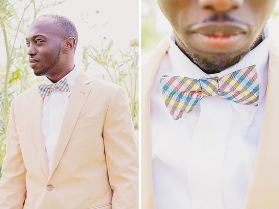 Man in tan suit wearing colorful bow tie