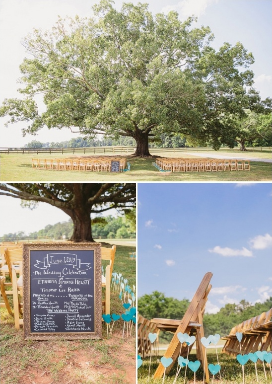 Rustic outdoor wedding ceremony setup under a large tree