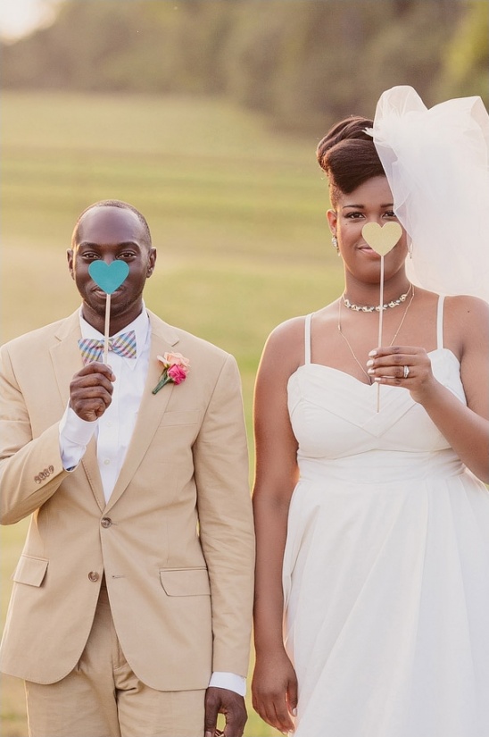 Happy couple holding heart-shaped signs
