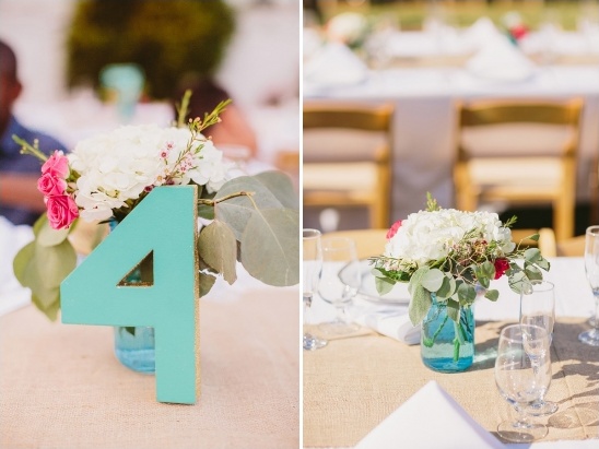 Teal table number four with white flowers