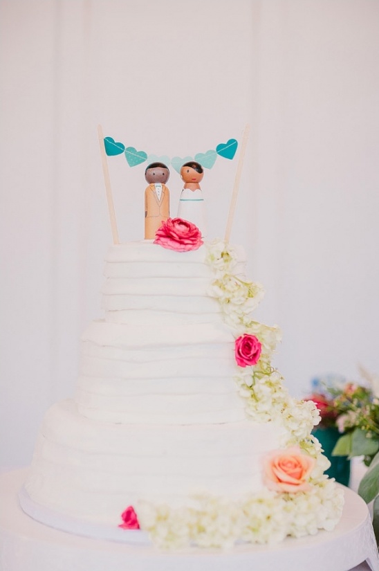 Wedding cake with wooden couple topper and flowers