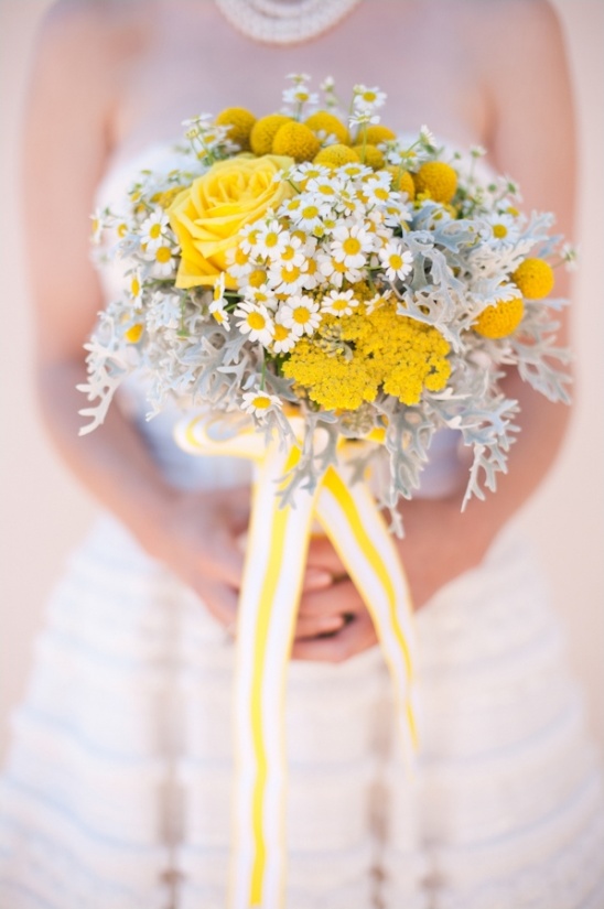 Bride holding yellow and white daisy wedding bouquet