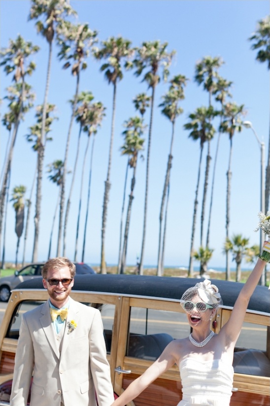 Beach wedding happy couple near woodie car palm trees