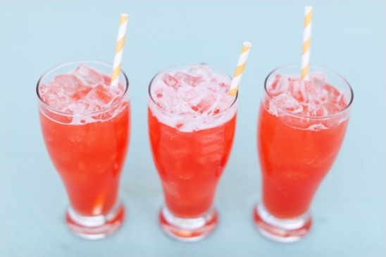 Three refreshing pink cocktails with striped straws
