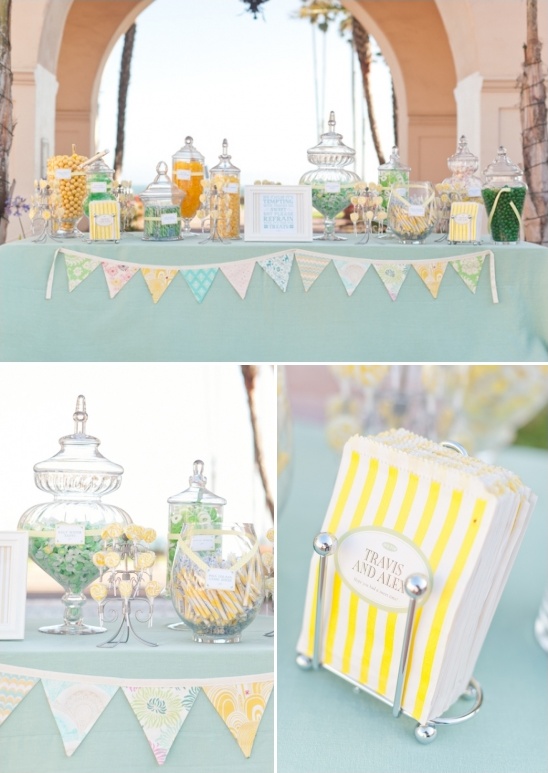 Candy buffet at a wedding reception with jars and banner