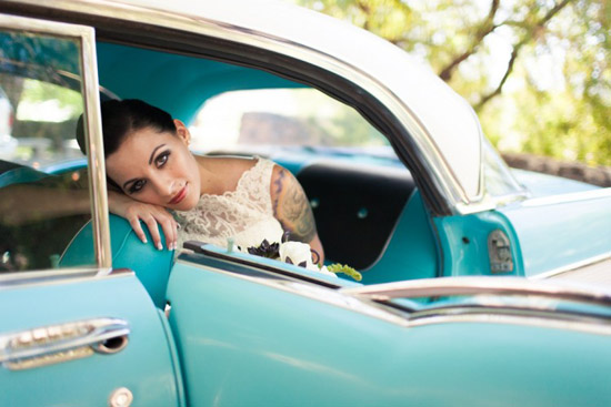 Vintage bride in a classic turquoise car wedding day