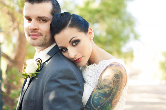 Tattooed bride leans on groom alternative wedding style