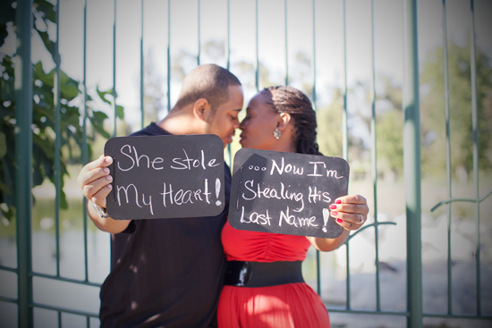 Engaged couple with signs She stole my heart