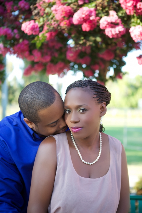 Loving black couple under a flowering tree portrait