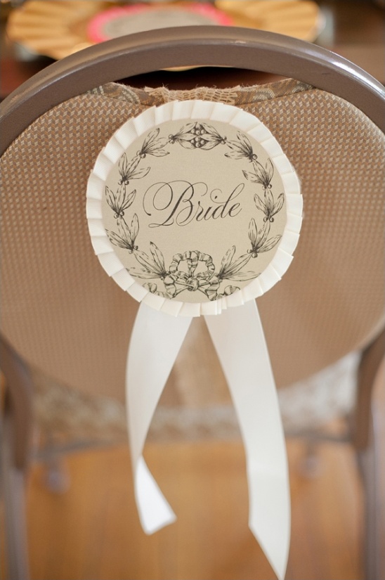 Bride rosette on chair for wedding decor