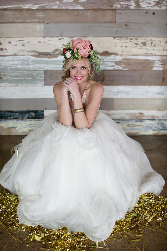 Smiling bride with flower crown in white tulle dress