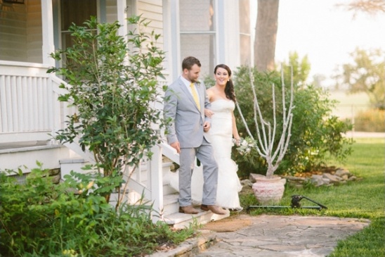Happy couple descending porch steps after wedding ceremony