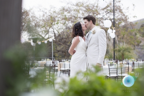 Bride and groom sharing a tender kiss at their wedding ceremony