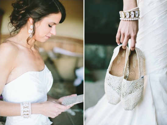 Bride reading letter, holding lace wedding shoes