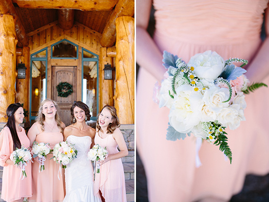 Bridesmaids in pink dresses hold bouquets at rustic wedding